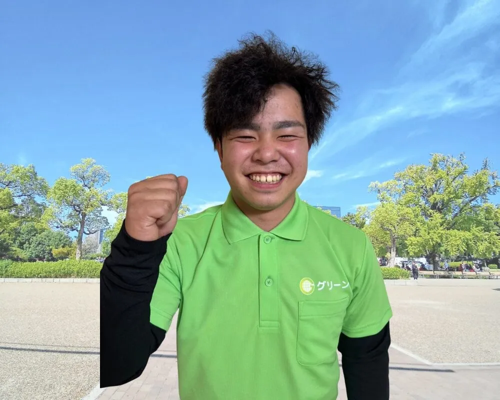 こぶしを上げて笑う、当社のスタッフ
